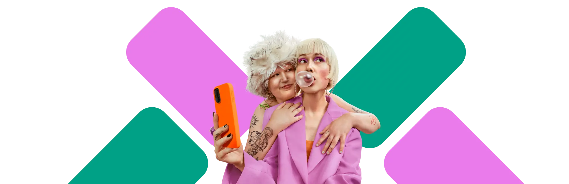 Zwei Personen in bunten Outfits posieren zusammen – eine hält ein Smartphone mit orangefarbener Hülle, die andere pustet eine Kaugummiblase.