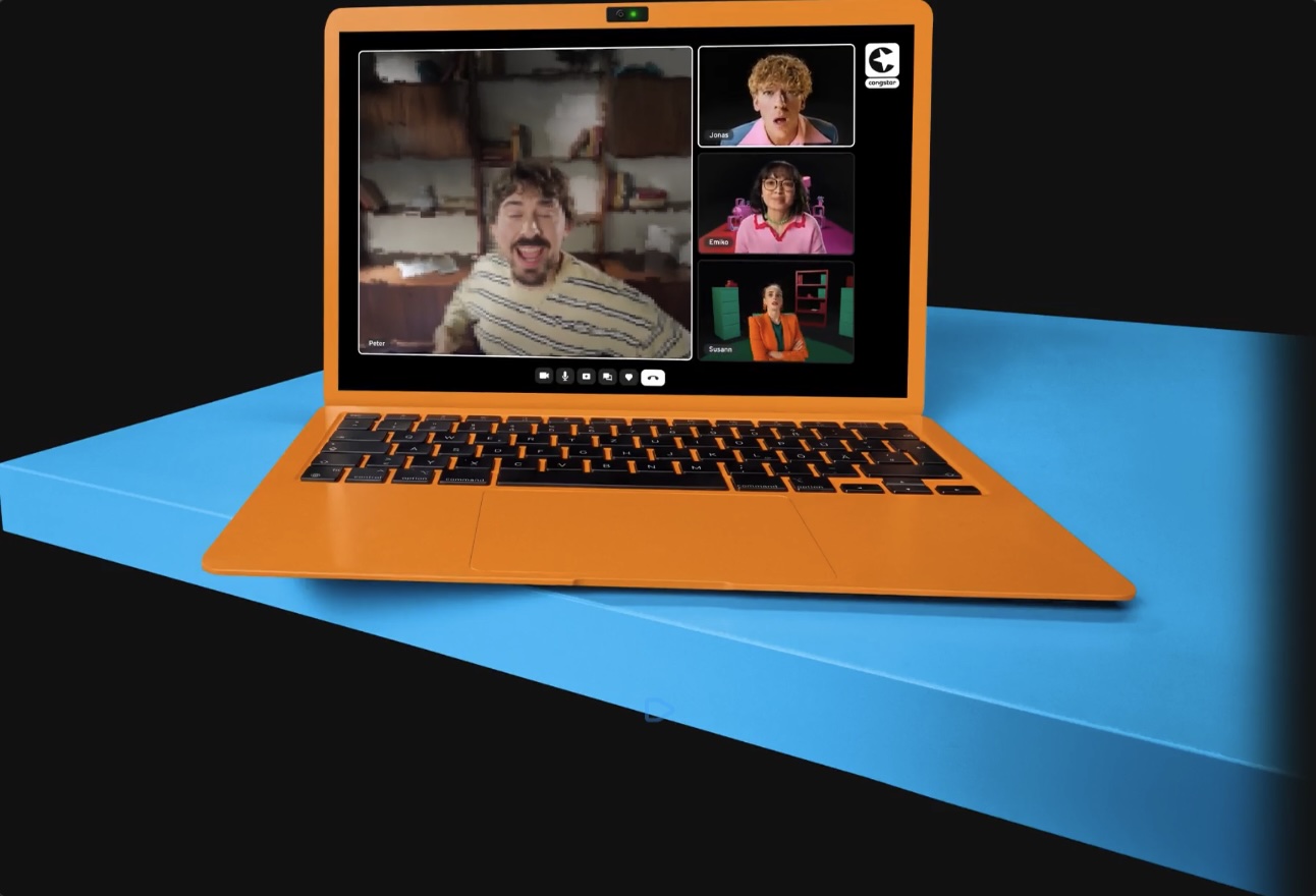 Laptop mit einem laufenden Videoanruf: eingefrorenes Bild einer Person im Hauptfenster, drei weitere Teilnehmende in Nebenfenstern.